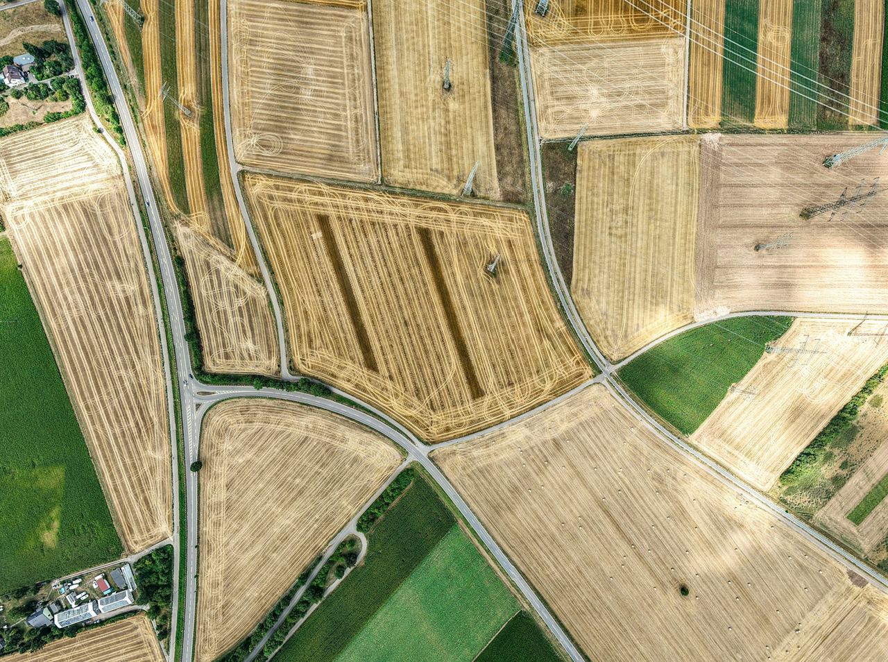 Aerial view of a patchwork of paddocks, each a different colour